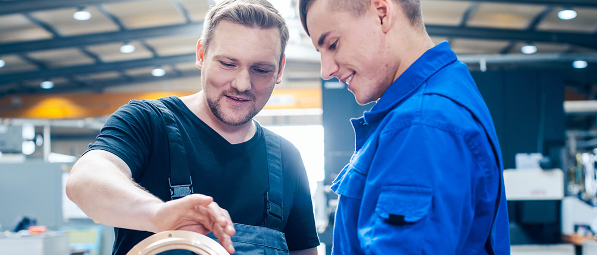 Skillful master discussing a workpiece with his apprentice or trainee Schlagwort(e): vocational training, Industry, worker, metalworking, trainee, Apprentice, metal, Mechanical engineering, man, men, training, explaining, engineering, steel construction, Metalworker, manufacturing, industrial, production, technician, factory, labor, laborer, Workshop, workplace, working, work, occupation, blue collar, manual, master, education, People, person, skilled, Caucasian, female, Germany, German, Absorbed, concentrated, precision